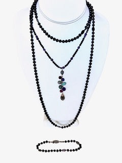 Long strand of hand knotted black pearls